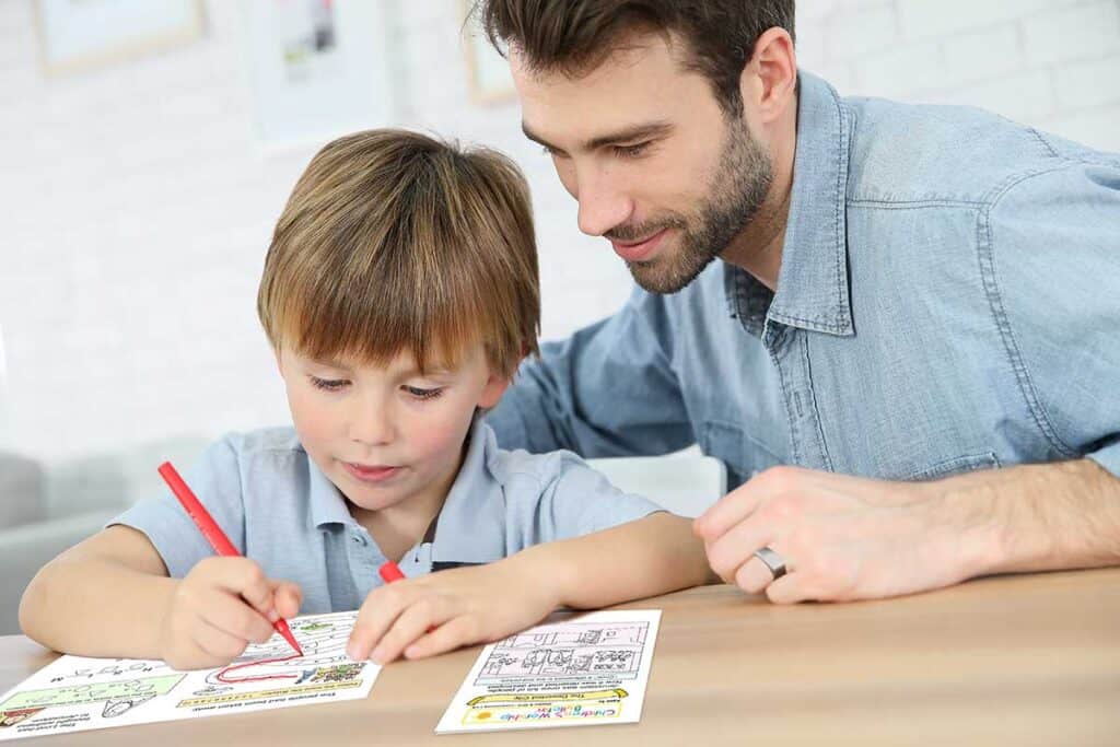 Daddy With Little Boy Making Drawings At Home
