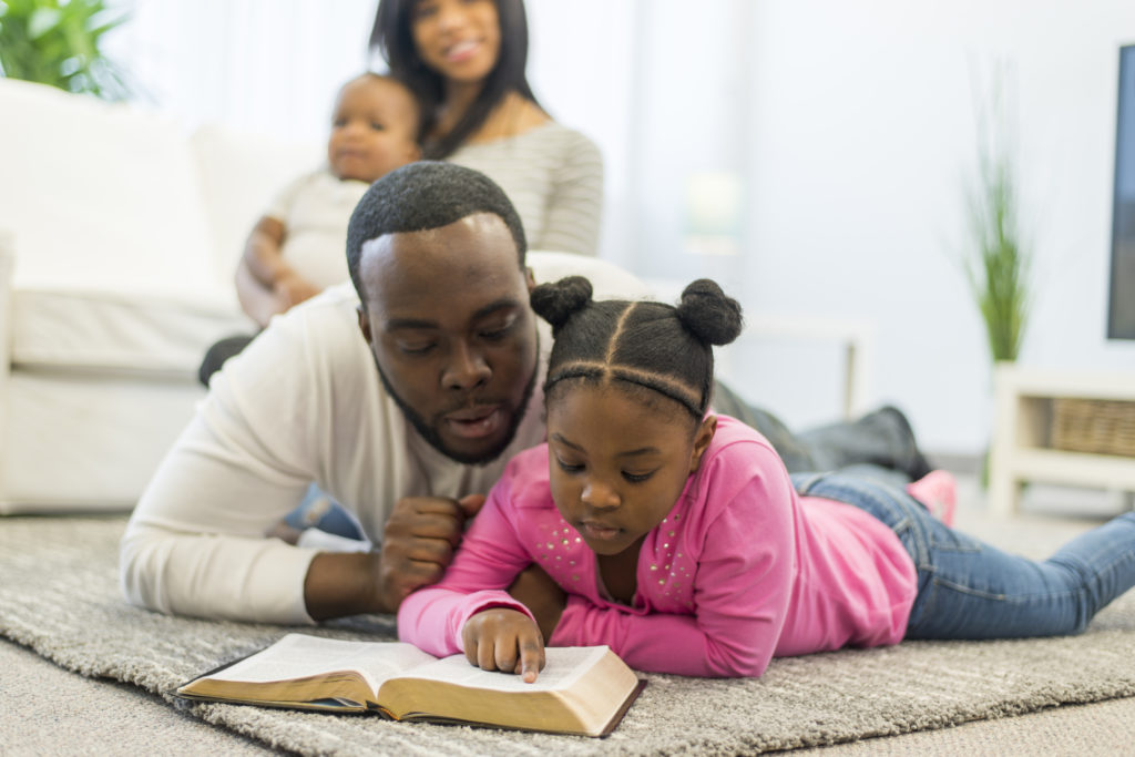 Family reading the Bible during the season of Lent