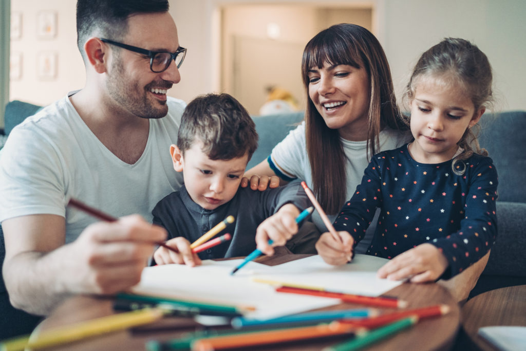 Photo of a Family writing notes to others for Lent