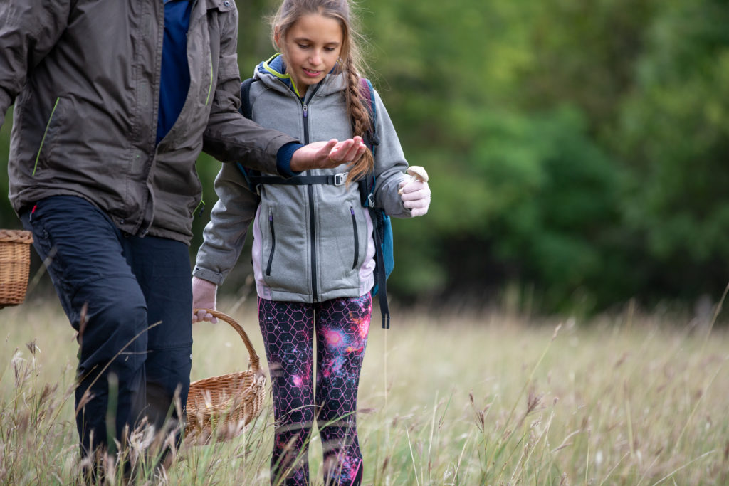 Photo of a father and daughter going on a nature scavenger hunt