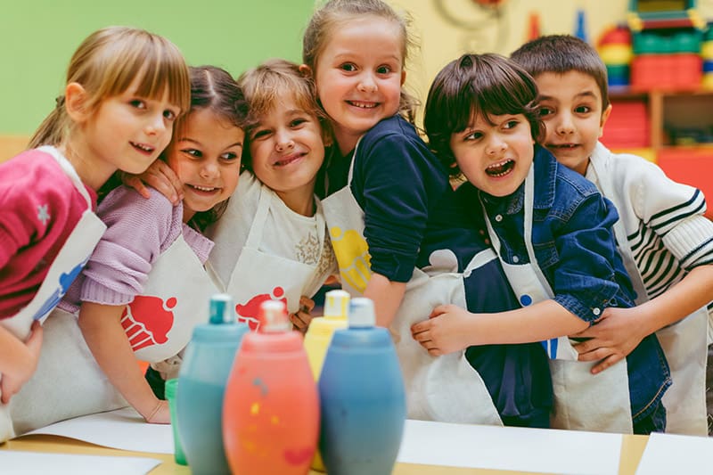 Portrait Of Children Painting With Watercolors