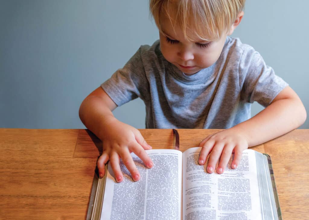Young child reading the Bible