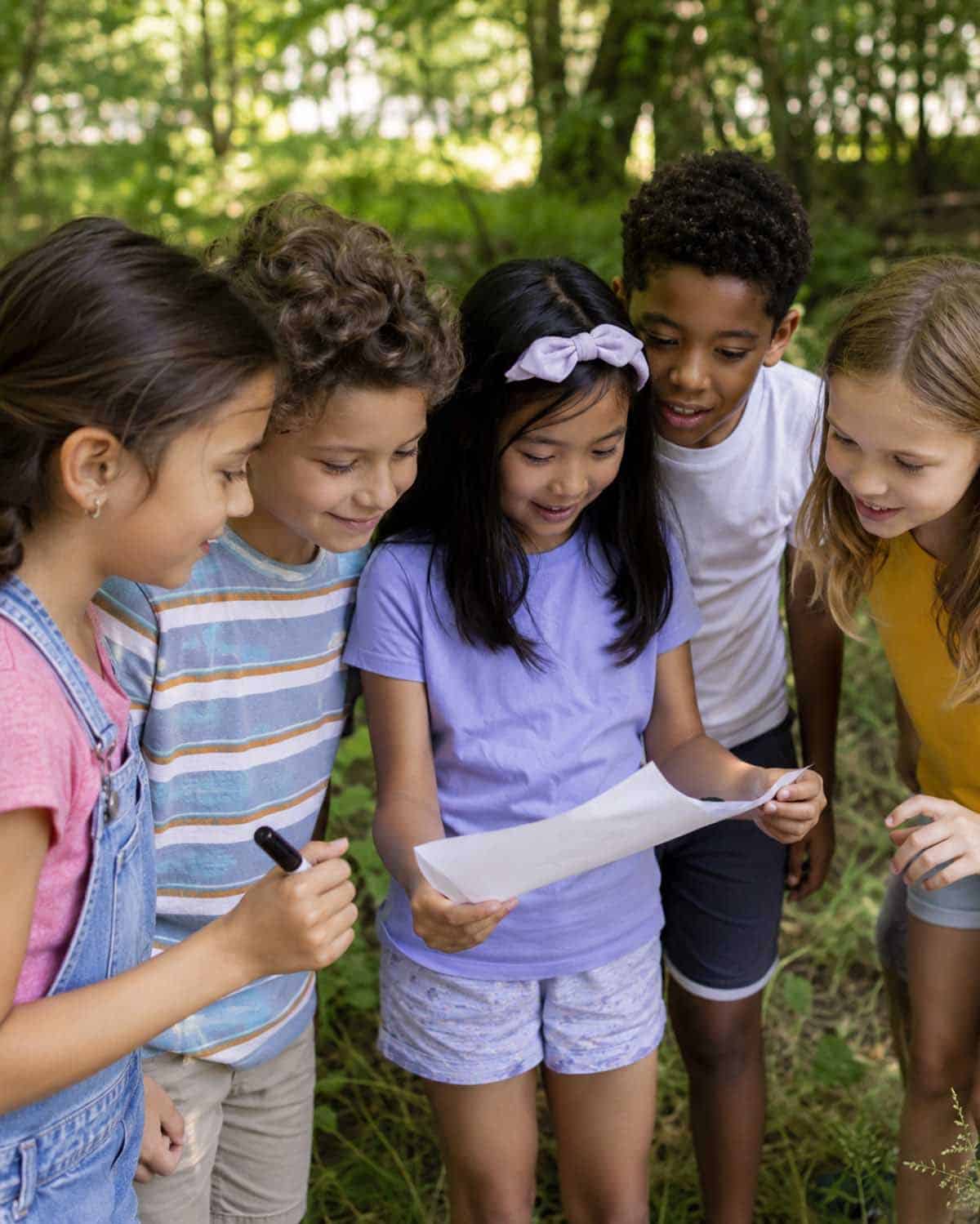 Kids participating in a Bible verse scavenger hunt during a fall festival. 